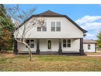 Charming two-story home with a black porch and white siding, offering a blend of modern and traditional style at 6219 Heardsville Rd, Cumming, GA 30028