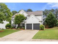 Charming two-story home with a well-manicured lawn and a two-car garage at 5156 Amberden Hall Dr, Suwanee, GA 30024
