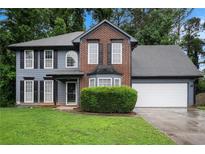 Traditional two-story home with brick and siding, featuring a well-manicured front yard at 6092 Giles Ct, Lithonia, GA 30058