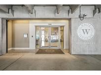 Modern building entrance featuring glass doors and prominent signage for White Provision Residences at 1100 Howell Mill Nw Rd # 212, Atlanta, GA 30318