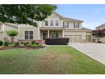 Charming two-story home with well-manicured lawn and three-car garage at 2921 Terra View Sw Dr, Lilburn, GA 30047