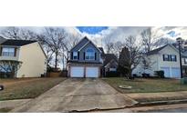 Charming two-story home featuring a two car garage and a well-maintained front yard at 1230 Chris Lake Dr, Lawrenceville, GA 30046