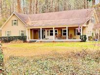 Charming single Gathering home featuring a large front porch and a well-maintained lawn at 230 White Rd, Fayetteville, GA 30214