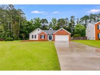 Charming single-story brick home with a well-manicured lawn and attached two-car garage at 4490 Epworth Court Ct, Powder Springs, GA 30127