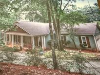 Charming single-story home featuring a welcoming porch and surrounded by lush greenery at 722 Beauregard Sw Dr, Marietta, GA 30064