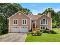 Charming two-story home with a well-manicured lawn and a two-car garage at 920 Highfield Ct, Lawrenceville, GA 30043