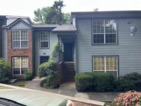 Charming condo building with a well maintained landscaped entryway and brick and vinyl siding at 1130 Weatherstone Ne Dr, Atlanta, GA 30324