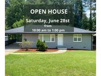 Charming single-story home with a well-manicured lawn and an open house sign at 2107 Garden Cir, Decatur, GA 30032