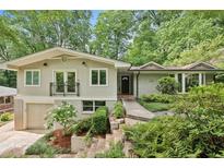 Inviting home exterior with a well-manicured lawn, beautiful foliage, and a charming balcony at 2481 Melinda Ne Dr, Atlanta, GA 30345