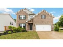 Charming brick home with well-manicured lawn and attached two-car garage, exuding curb appeal at 1504 Lemon Balm Ct, Lawrenceville, GA 30045