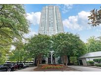 Striking high-rise condominium exterior with mature trees and manicured landscaping in a beautiful city setting at 2870 Pharr Court South Nw # 1704, Atlanta, GA 30305