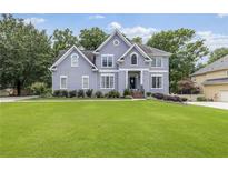 Charming two-story home with a large front lawn and beautiful landscaping at 1634 Crittenden Ln, Lawrenceville, GA 30043