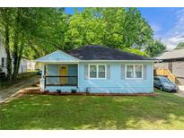 Charming bungalow home features a freshly landscaped lawn, welcoming front porch, and inviting curb appeal at 1396 Elizabeth Ln, Atlanta, GA 30344