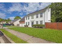 Charming two-story home with a well-manicured lawn, framed by trees and blue skies at 3822 River Ridge Ct, Decatur, GA 30034