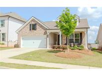 Charming single-Gathering home with a well-manicured front lawn, a two-car garage, and a cozy front porch at 3397 Long Creek Drive, Buford, GA 30519