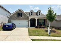 Charming single-Gathering home featuring a two-car garage, well-kept lawn, and inviting front porch at 3397 Long Creek Drive, Buford, GA 30519