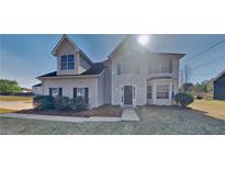 Charming two-story home with light siding, well-maintained landscaping, and a welcoming entrance at 4688 Snap Creek Ln, Decatur, GA 30035