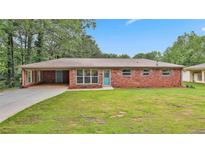 Charming single-story brick home with a spacious front yard and attached carport at 191 Pine Ne St, Fairburn, GA 30213
