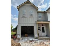 Two-story home with open garage, showcasing modern design and curb appeal at 31 Benscot Dr, Austell, GA 30106