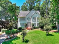 Charming two-story home with manicured lawn and mature trees at 1875 Skidmore Cir, Lawrenceville, GA 30044