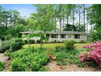 Charming single-story home with well-manicured lawn and mature trees at 5839 Darry Cir, Norcross, GA 30093