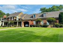 Stunning two-story brick home features a well manicured front yard and attached garage at 1695 Whitley Rd, Dacula, GA 30019