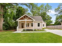 Charming single-story home with a well-manicured lawn and inviting front porch at 1036 Dell Se Ave, Smyrna, GA 30080