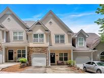 Charming townhome with stone accents, attached garage, and inviting front porch in a desirable community at 2205 Hoskin Nw Ct # 9, Kennesaw, GA 30144