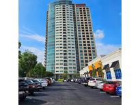 Modern high-rise apartment building with a parking lot in front and commercial space to the side at 4561 Olde Perimeter Way # 608, Dunwoody, GA 30346