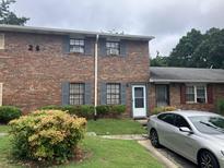 Brick multifamily with gray shutters, trimmed bushes, and a gray car parked in front at 6354 Shannon Pkwy # 26C, Union City, GA 30291