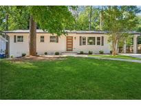 Charming one story home with a freshly manicured lawn and painted brick exterior at 2595 Elkhorn Dr, Decatur, GA 30034