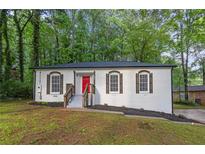 Charming renovated bungalow features a red front door and freshly painted exterior at 4698 Fellsridge Dr, Stone Mountain, GA 30083