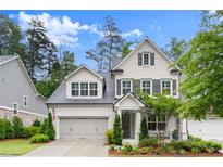 Beautiful two-story home featuring gray painted brick, gray shutters, and a well-manicured lawn at 124 Calder Dr, Alpharetta, GA 30009