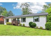 Charming, freshly painted home features a well-maintained lawn and welcoming front porch at 3036 Horse Shoe Se Dr, Atlanta, GA 30316