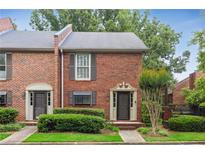 Charming brick townhome featuring a well-manicured lawn and traditional architectural details on a sunny day at 1245 S Ponce De Leon Ne Ave # 13, Atlanta, GA 30306