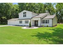 Charming two-story home features a manicured lawn, a two-car garage, and classic black shutters at 3729 Meadow Glen Cir, Ellenwood, GA 30294
