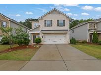 Charming two-story home featuring a brick facade, two-car garage, and a well-maintained front yard at 1998 Nuthatch Dr, Hoschton, GA 30548
