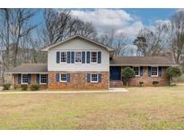 Charming brick home featuring blue shutters and a well-maintained front yard, offering a classic and inviting curb appeal at 2270 Old Concord Se Dr, Covington, GA 30016