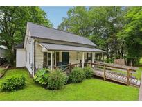 Charming cottage-style home with a welcoming front porch and a convenient handicap ramp at 2860 Jefferson St, Austell, GA 30106