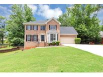 Charming two-story brick home with well-manicured lawn and attached two-car garage at 4810 Habersham Se Way, Conyers, GA 30094