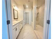 Bright bathroom featuring double vanity and marble-tiled walk-in shower at 518 Healy Dr # 68, Cumming, GA 30040