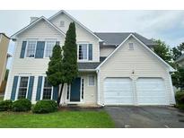 Charming two-story home with a well-maintained front yard and a two-car garage at 690 Kimball Parc Way, Alpharetta, GA 30022
