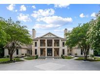 Stunning two-story home boasting a symmetrical facade, manicured landscaping, and an inviting driveway at 1430 N Harris Rdg, Atlanta, GA 30327