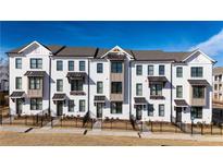 Charming new townhomes with brick exterior and black trim create sophisticated street appeal at 532 Healy Dr # 61, Cumming, GA 30040