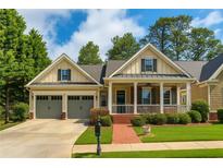 Charming single-Gathering home with a welcoming front porch, a well-manicured lawn, and a two-car garage at 730 Jackson Miller Cir, Powder Springs, GA 30127