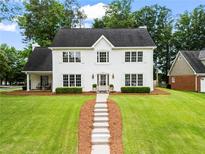 Charming two-story home with landscaped lawn and inviting walkway leading to the front door at 600 Delphinium Nw Blvd, Acworth, GA 30102