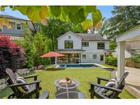 Outdoor living with pool, fire pit, and lounge chairs on artificial turf, perfect for relaxing and entertaining at 1168 Mclynn Ne Ave, Atlanta, GA 30306