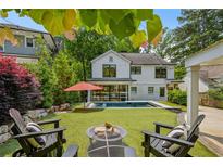 Beautiful backyard featuring a pool, patio with fire pit and well-manicured landscaping at 1168 Mclynn Ne Ave, Atlanta, GA 30306