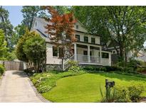 Charming two-story home with a welcoming front porch and professionally landscaped yard at 1168 Mclynn Ne Ave, Atlanta, GA 30306