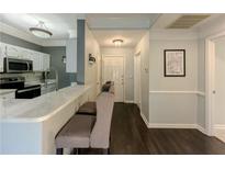 Inviting entryway with a kitchen view, hardwood floors, and white trim at 2700 Pine Tree Ne Rd # 1013, Atlanta, GA 30324